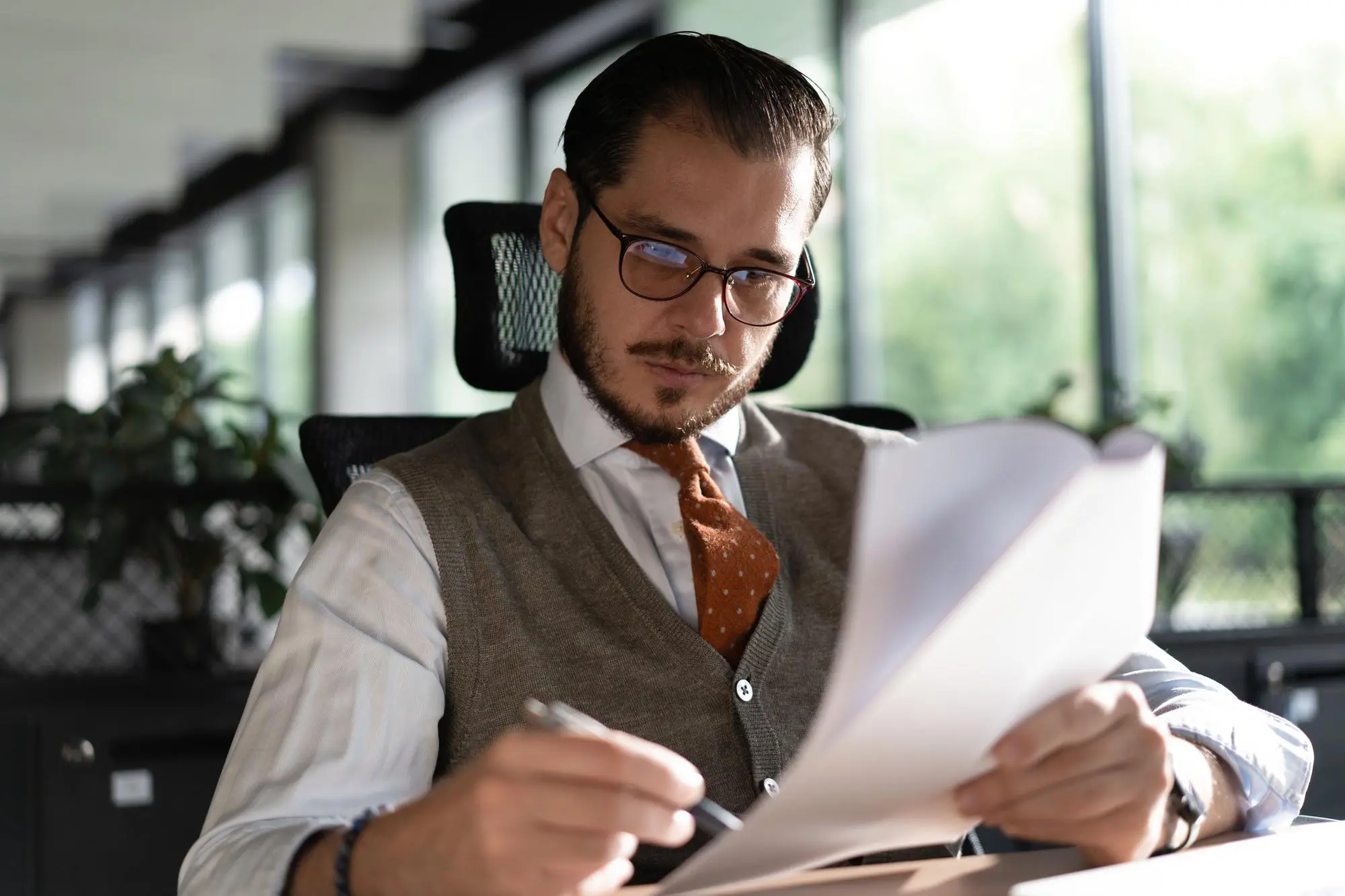 Satisfied businessman reading paper documents letters receiving pleasant news freelancer looking at contract with good offer