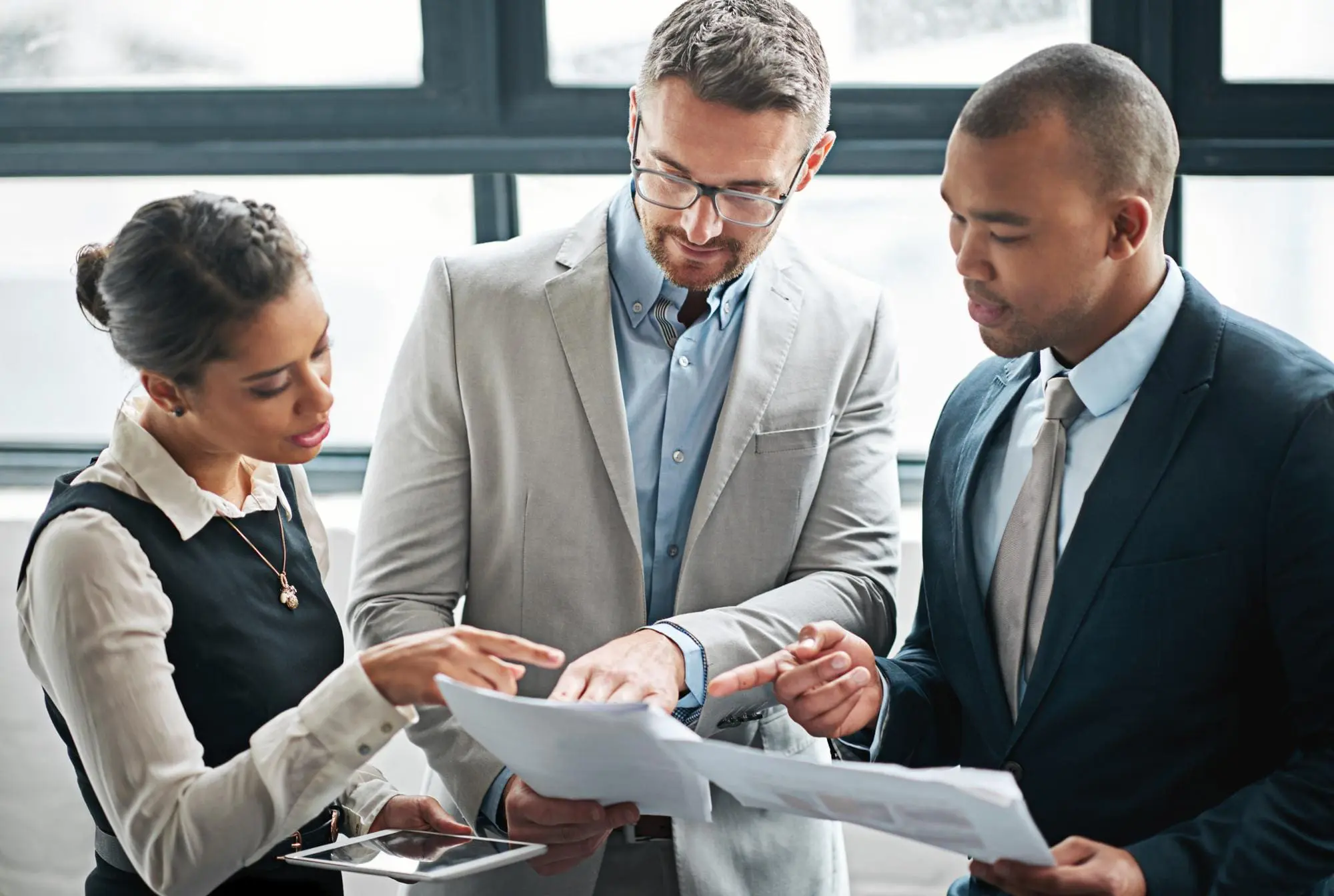 Documents meeting and business people in discussion for planning advice and collaboration Corporate office teamwork and men and woman with p