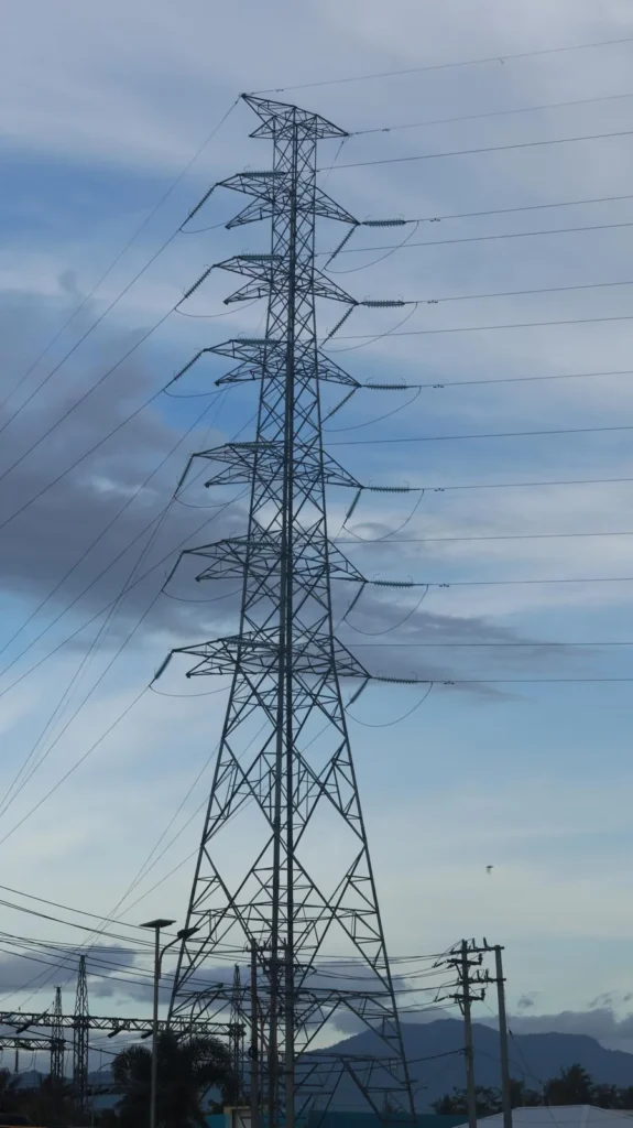 High-voltage electricity transmission towers at dusk
